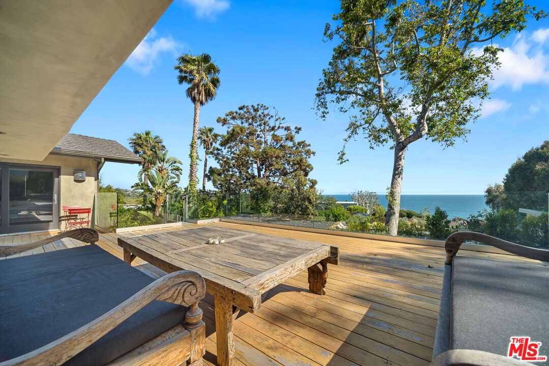 31226 Bailard Road Malibu, CA 90265 - Photo 16 of 40 a view of a patio with a table and chairs