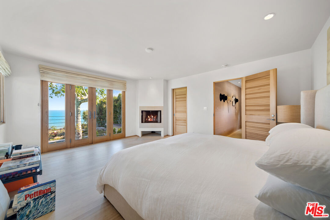 31226 Bailard Road Malibu, CA 90265 - Photo 27 of 40 a bedroom with a bed and a large window