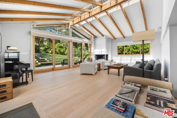 a living room with furniture and large windows