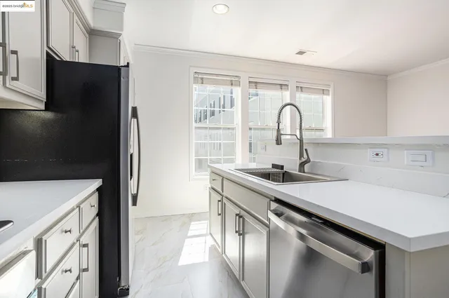 a kitchen with a sink and a refrigerator