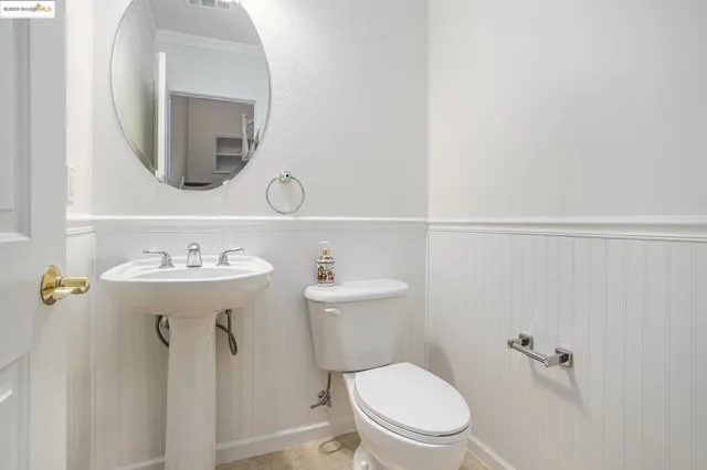 a bathroom with a sink mirror toilet and vanity
