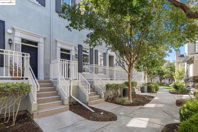 a view of a building with a bench in the patio