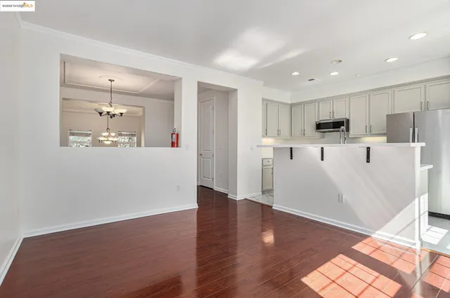 a view of a kitchen with wooden floor and a window