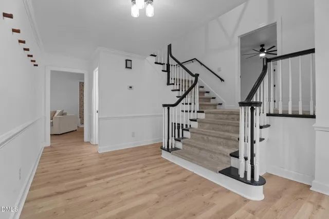 a view of entryway and hall with wooden floor