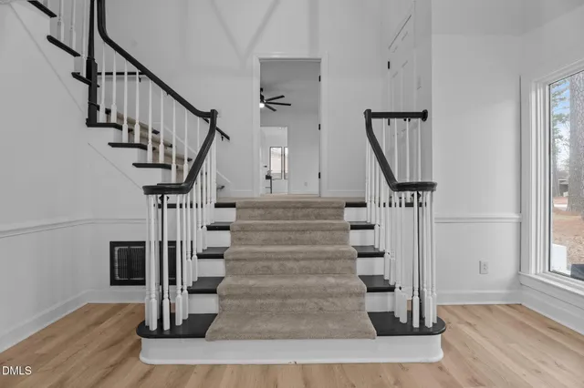 a view of entryway and hall with wooden floor