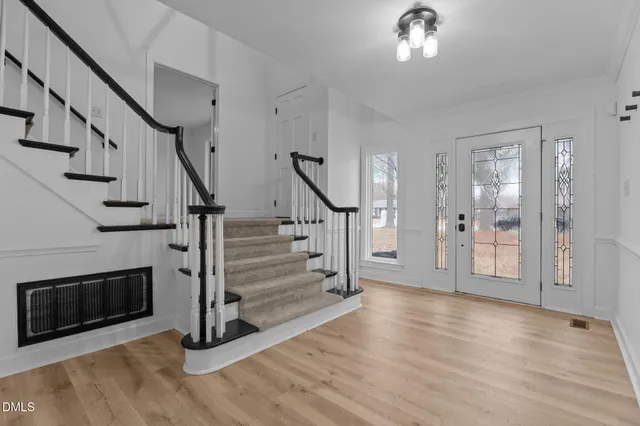 a view of entryway with wooden floor and a front door