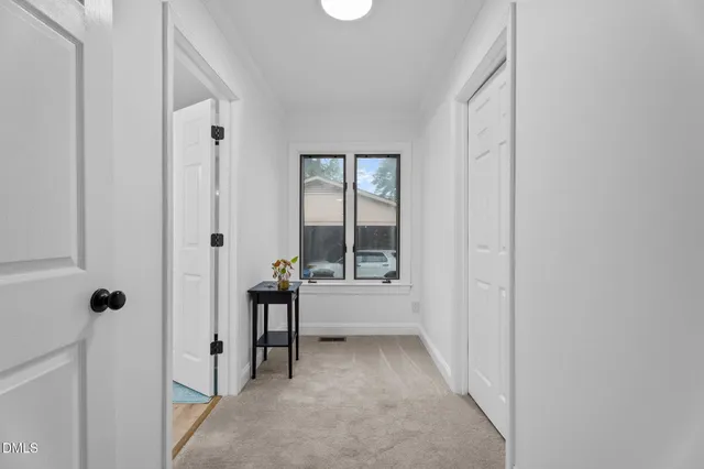 a view of a bathroom with tub window and mirror