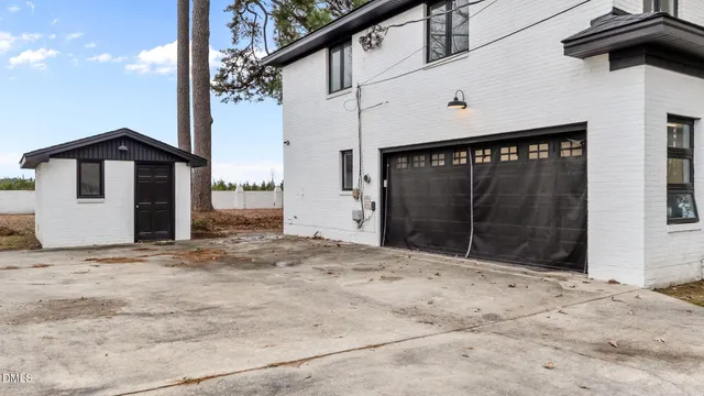 a front view of a house with yard and seating space
