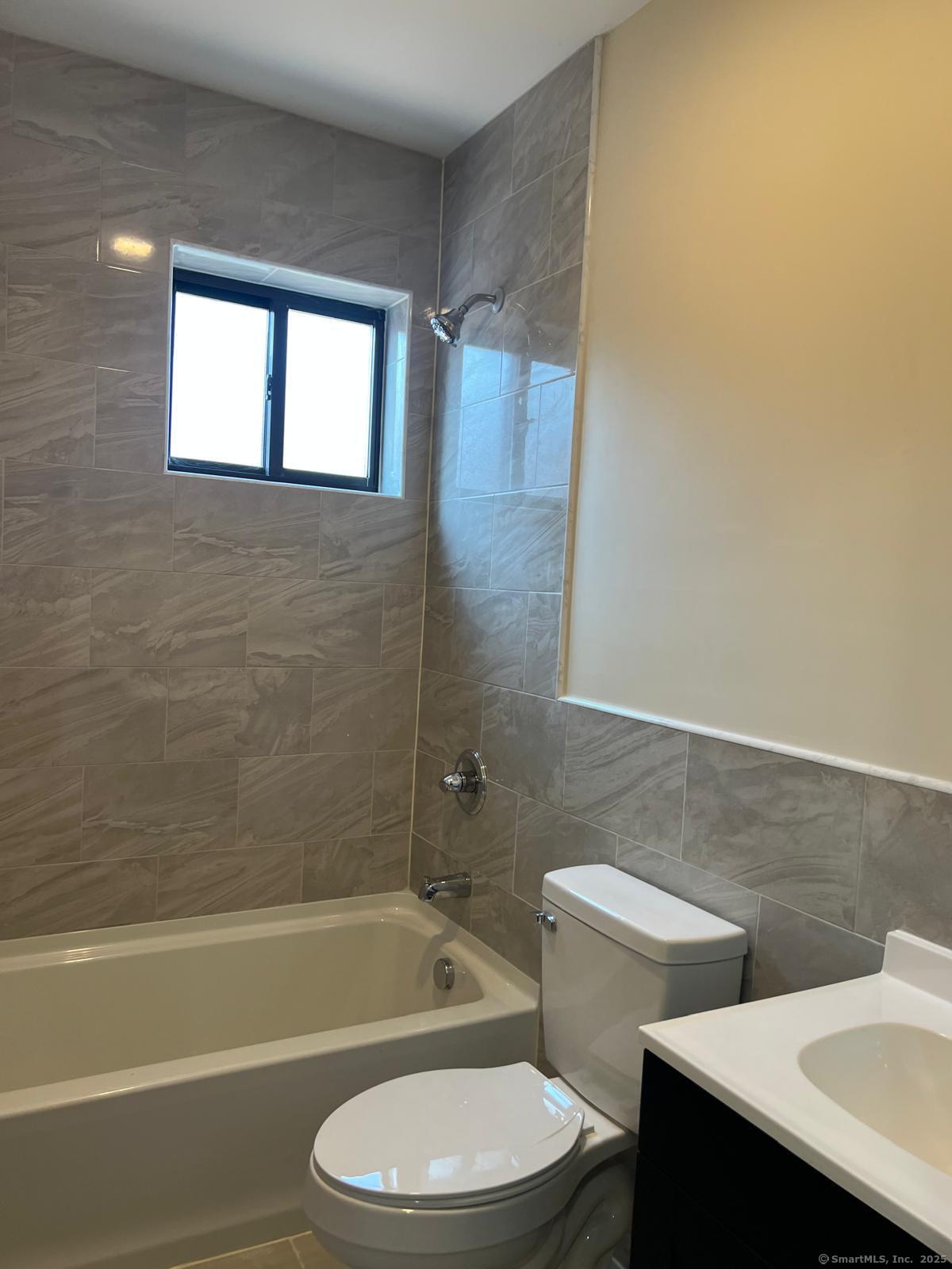 79 Barbour Street, Unit N1 Hartford, CT 06120 - Photo 6 of 6 a bathroom with a toilet a sink and bathtub