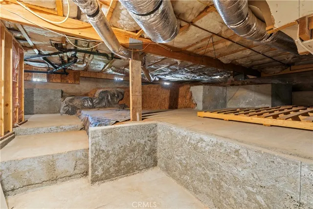 a backyard of a house with barbeque oven table and chairs