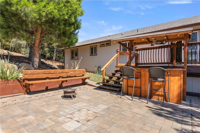 a view of a house with a yard and sitting area