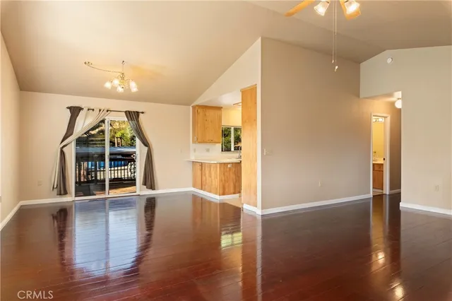 a view of a kitchen with furniture and wooden floor