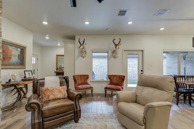 a living room with furniture wooden floor and a flat screen tv