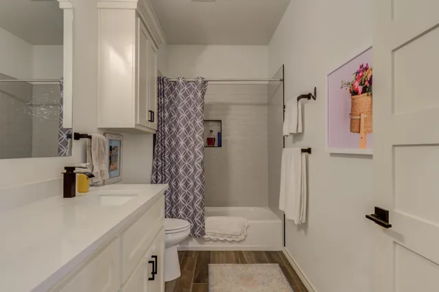 a bathroom with a shower and a sink