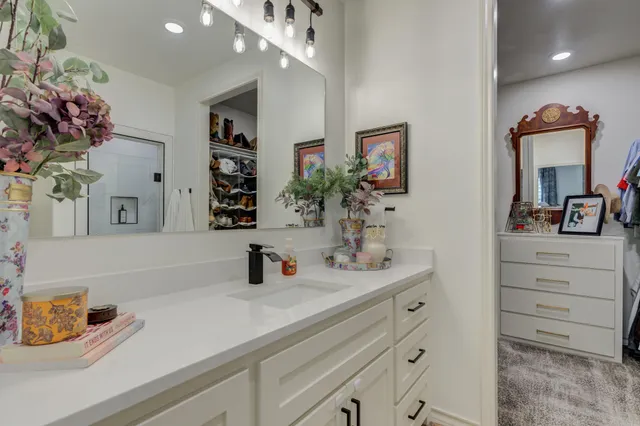 a bathroom with a sink double vanity and a mirror