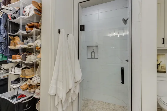 a bathroom with a shower and a mirror