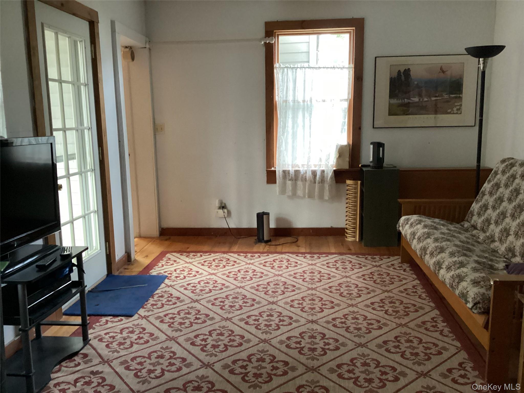 302 Todd Road, Unit T Woodbourne, NY 12788 - Photo 12 of 14 a bedroom with a bed and wooden floor