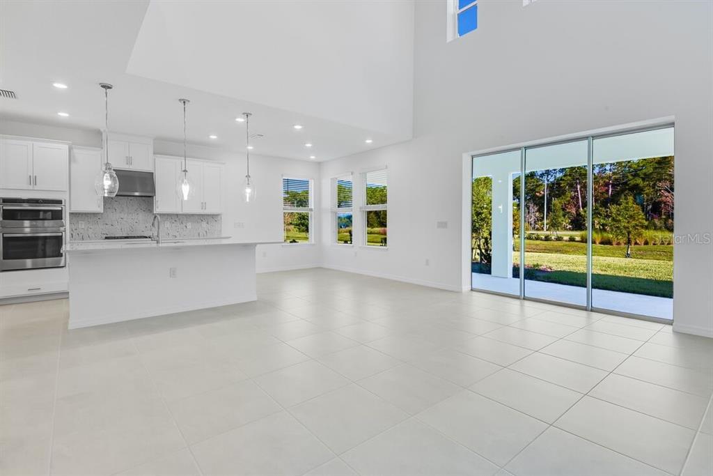 581 Moon Shell Circle New Smyrna Beach, FL 32168 - Photo 13 of 40 a view of an empty room with a kitchen stove back oven