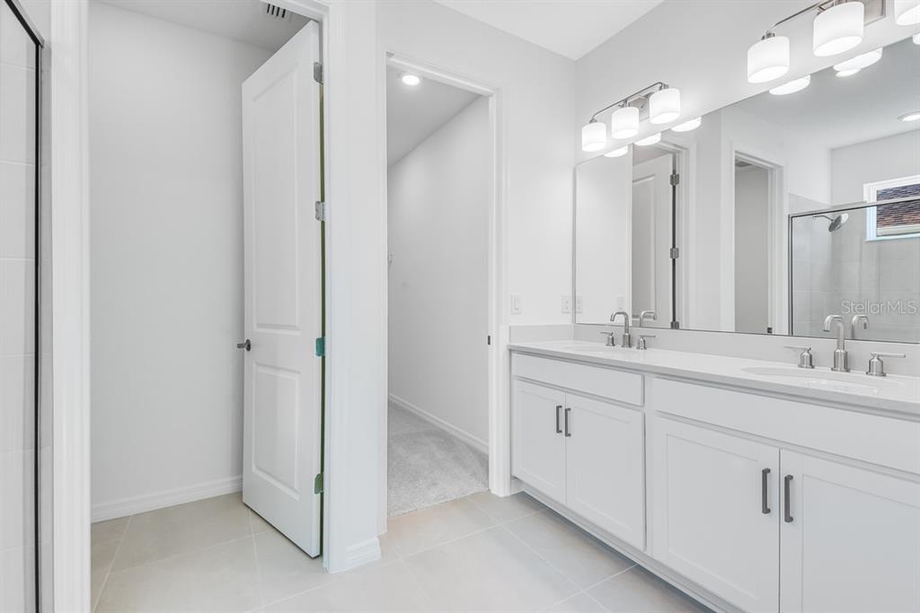 581 Moon Shell Circle New Smyrna Beach, FL 32168 - Photo 17 of 40 a bathroom with double sink and a mirror