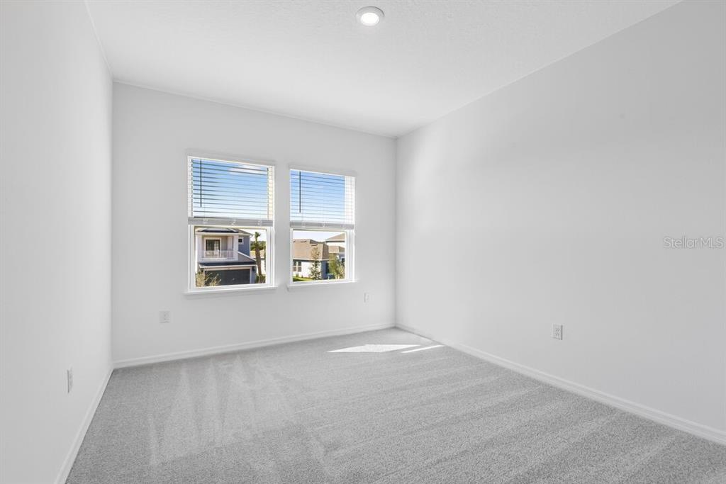 581 Moon Shell Circle New Smyrna Beach, FL 32168 - Photo 21 of 40 a view of an empty room with windows
