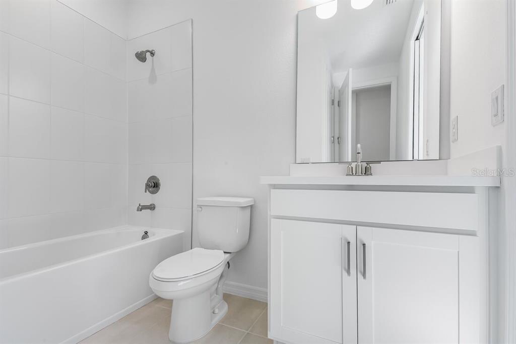 581 Moon Shell Circle New Smyrna Beach, FL 32168 - Photo 23 of 40 a bathroom with a sink a toilet and shower