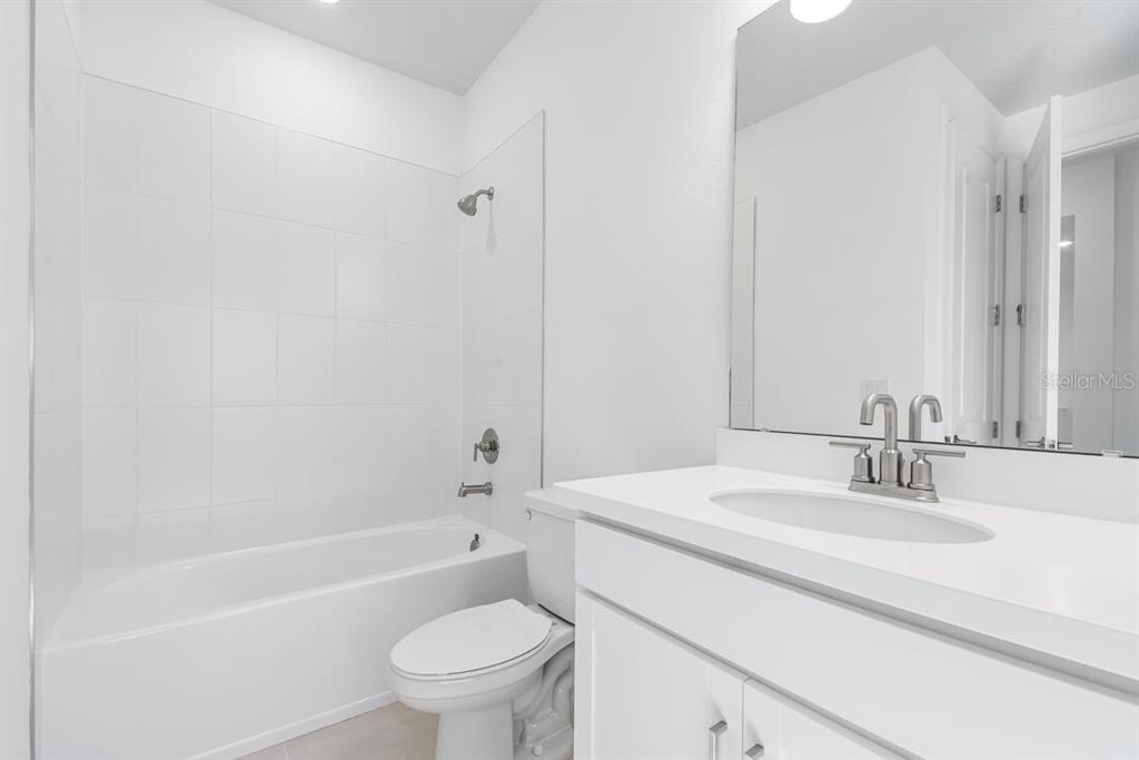 581 Moon Shell Circle New Smyrna Beach, FL 32168 - Photo 24 of 40 a bathroom with a sink toilet and a bathtub