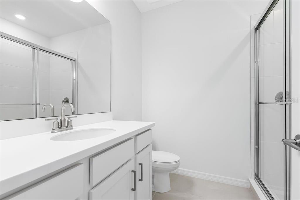 581 Moon Shell Circle New Smyrna Beach, FL 32168 - Photo 26 of 40 a bathroom with a sink toilet and vanity