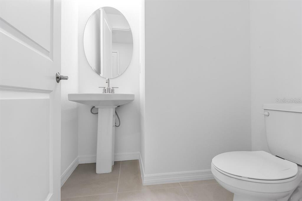 581 Moon Shell Circle New Smyrna Beach, FL 32168 - Photo 27 of 40 a bathroom with a toilet sink and mirror