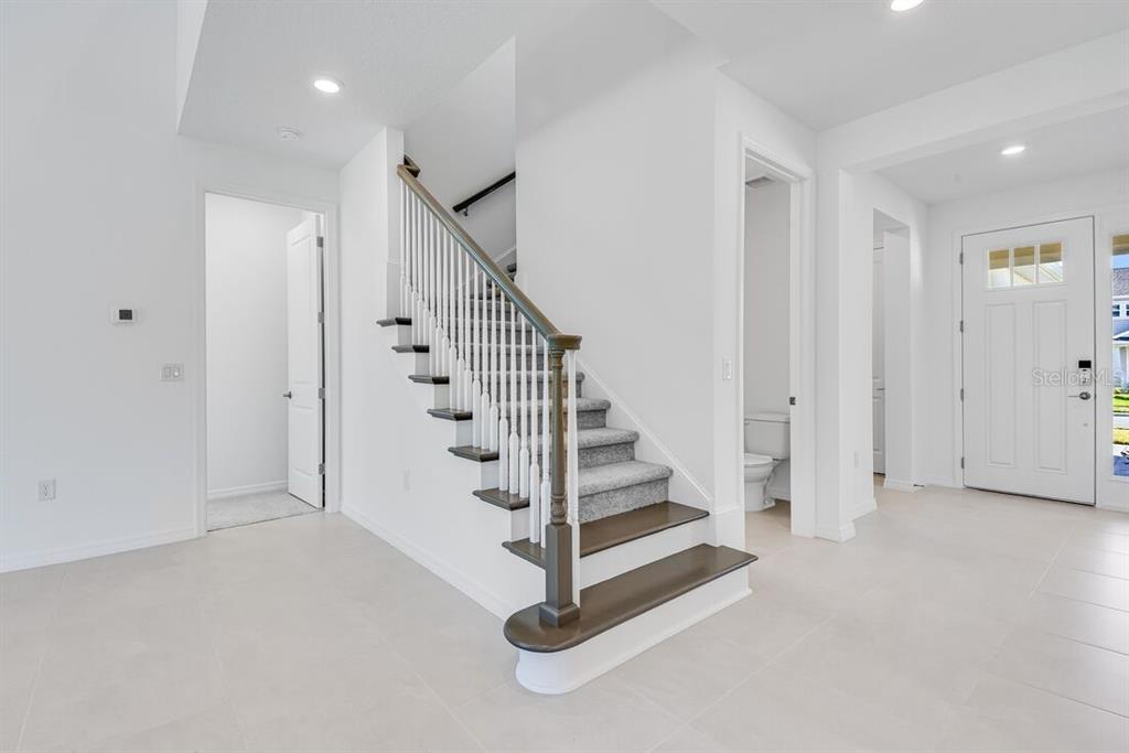 581 Moon Shell Circle New Smyrna Beach, FL 32168 - Photo 28 of 40 a view of entryway with wooden floor and stairs