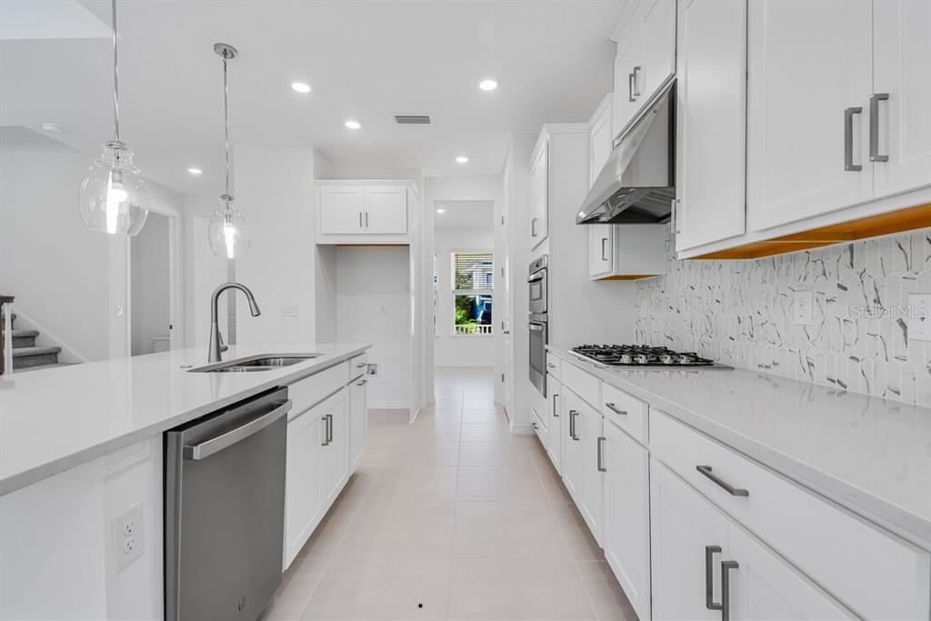 581 Moon Shell Circle New Smyrna Beach, FL 32168 - Photo 8 of 40 a open kitchen with stainless steel appliances granite countertop a sink a stove and a refrigerator