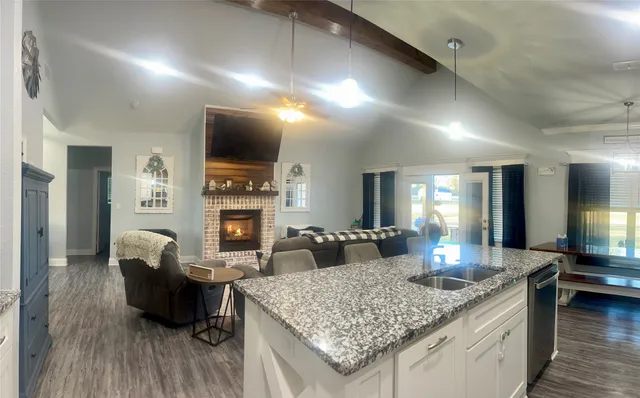 a kitchen with a counter space a sink appliances and cabinets
