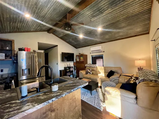 a living room with furniture a rug and a fireplace