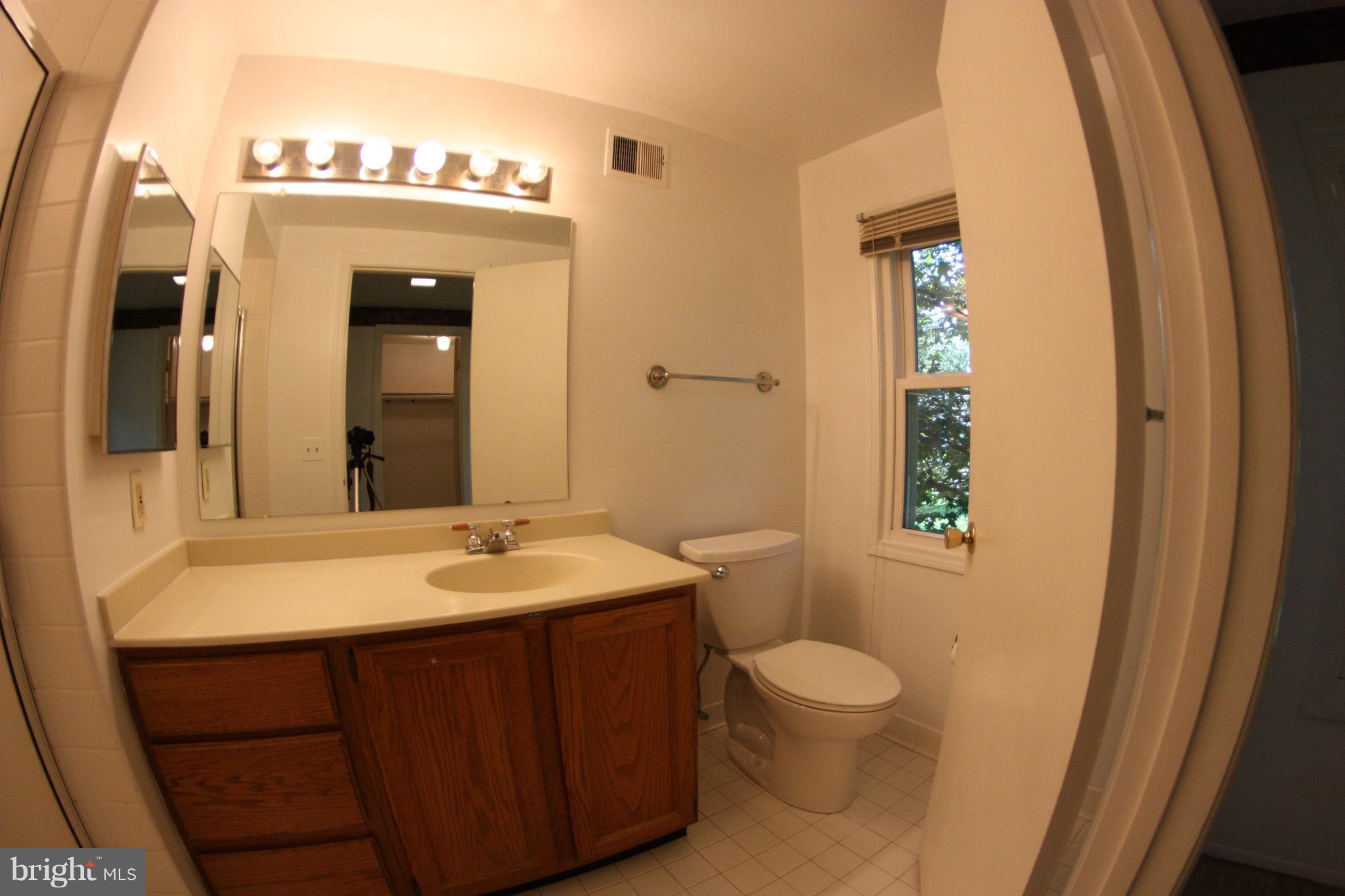 2425 Countryside Drive Silver Spring, MD 20905 - Photo 20 of 24 a bathroom with a sink and a mirror