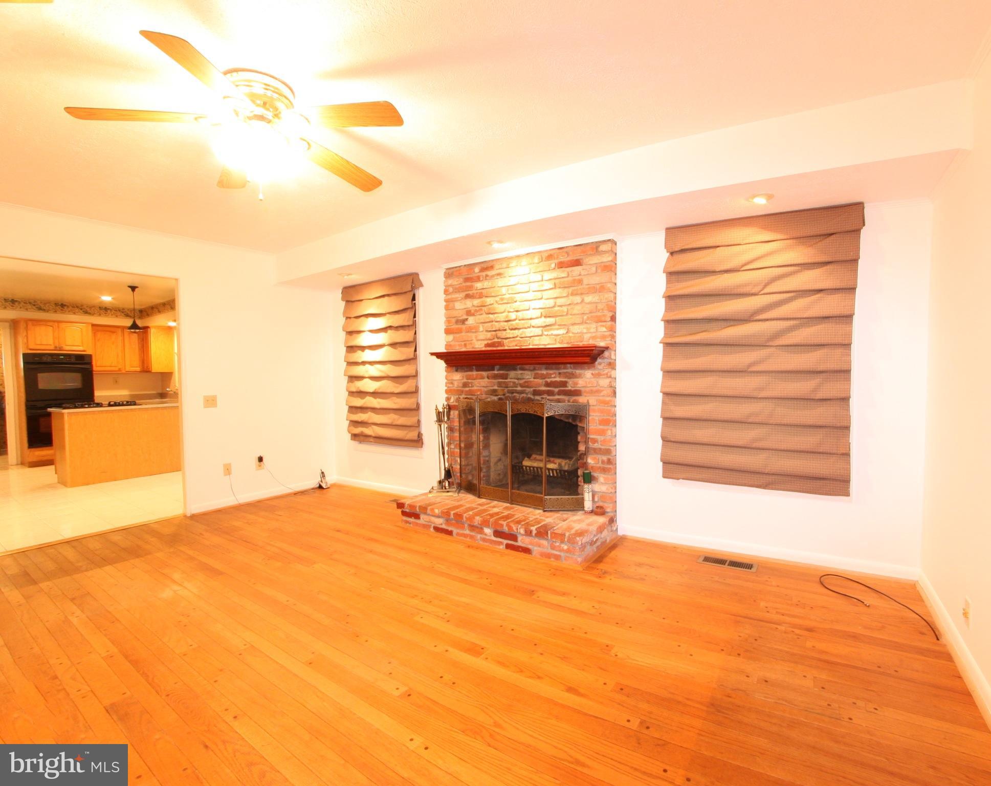 2425 Countryside Drive Silver Spring, MD 20905 - Photo 4 of 24 a view of an empty room with a fireplace and a window