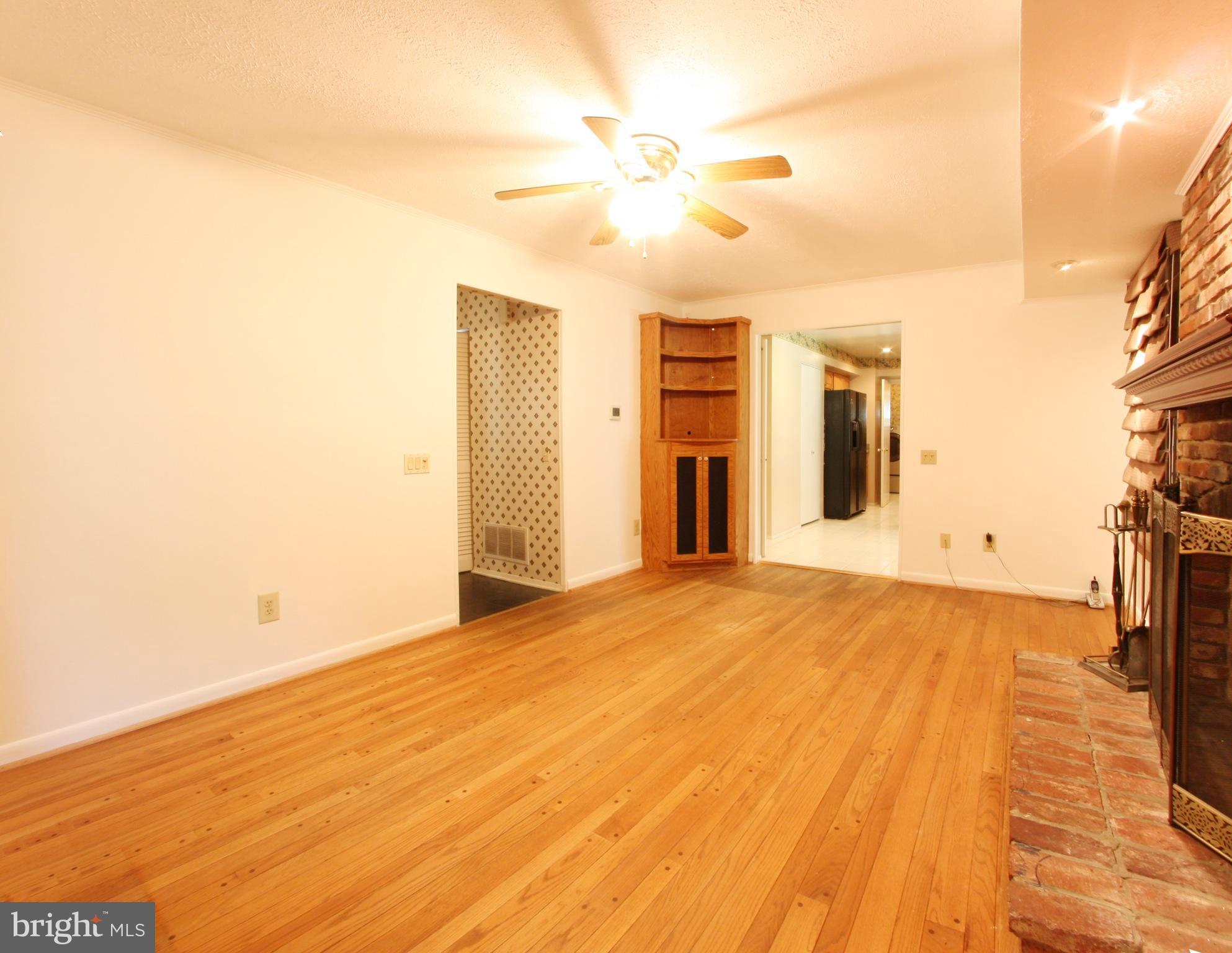 2425 Countryside Drive Silver Spring, MD 20905 - Photo 5 of 24 a view of empty room with wooden floor and fan