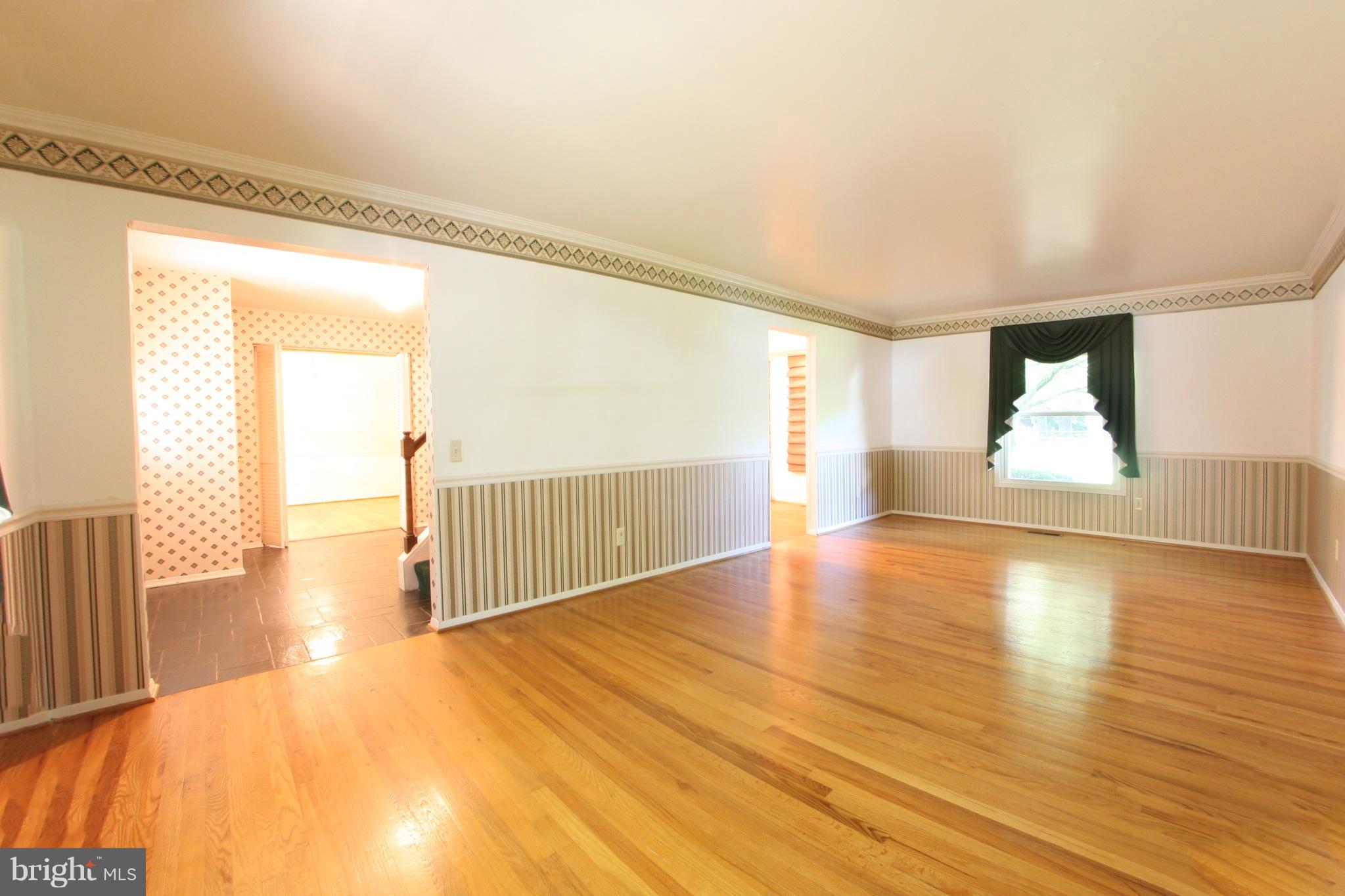 2425 Countryside Drive Silver Spring, MD 20905 - Photo 10 of 24 a view of an empty room with wooden floor and a window