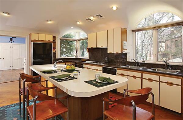 145 Lee Street Brookline, MA 02445 - Photo 7 of 12 a kitchen with a sink a stove a table and chairs