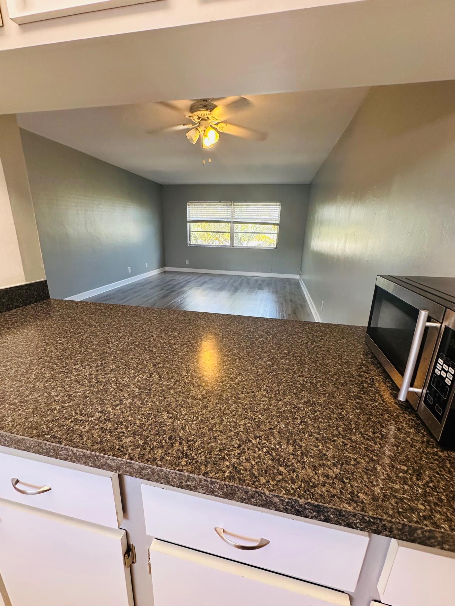 761 Hummingbird Way, Unit 205 North Palm Beach, FL 33408 - Photo 15 of 16 a view of a living room and bathroom
