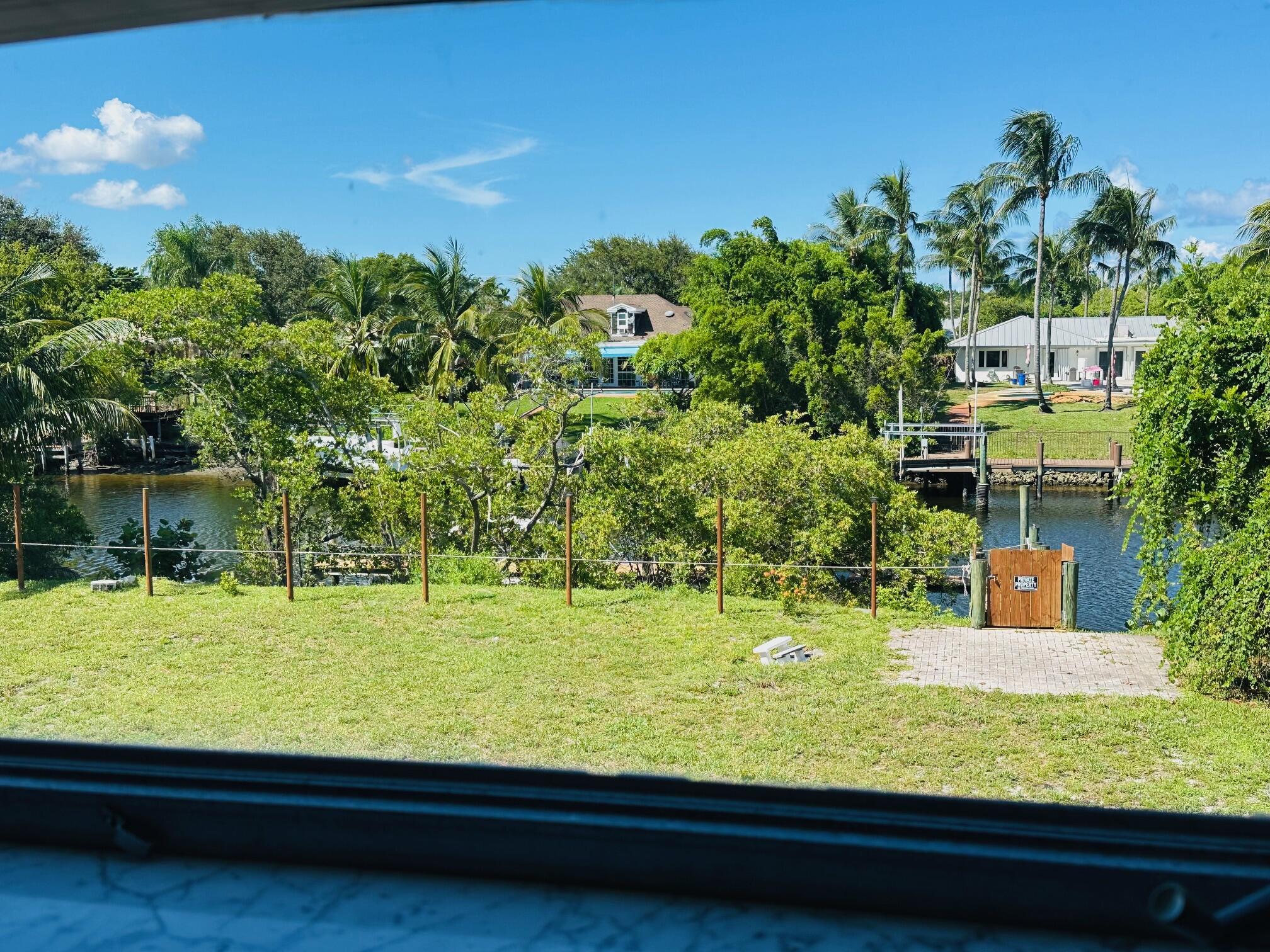 761 Hummingbird Way, Unit 205 North Palm Beach, FL 33408 - Photo 16 of 16 a view of swimming pool from a lake view