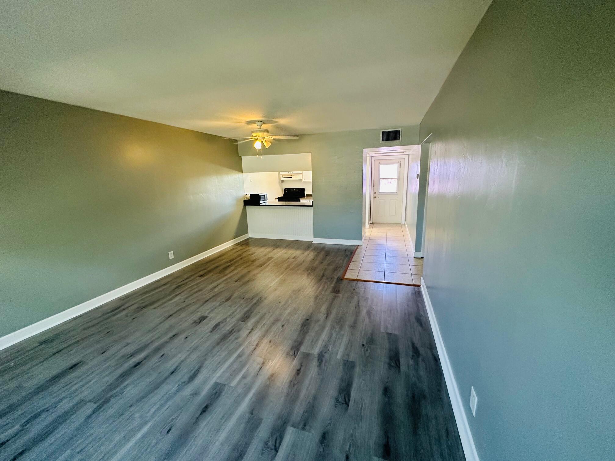 761 Hummingbird Way, Unit 205 North Palm Beach, FL 33408 - Photo 5 of 16 a view of empty room with wooden floor