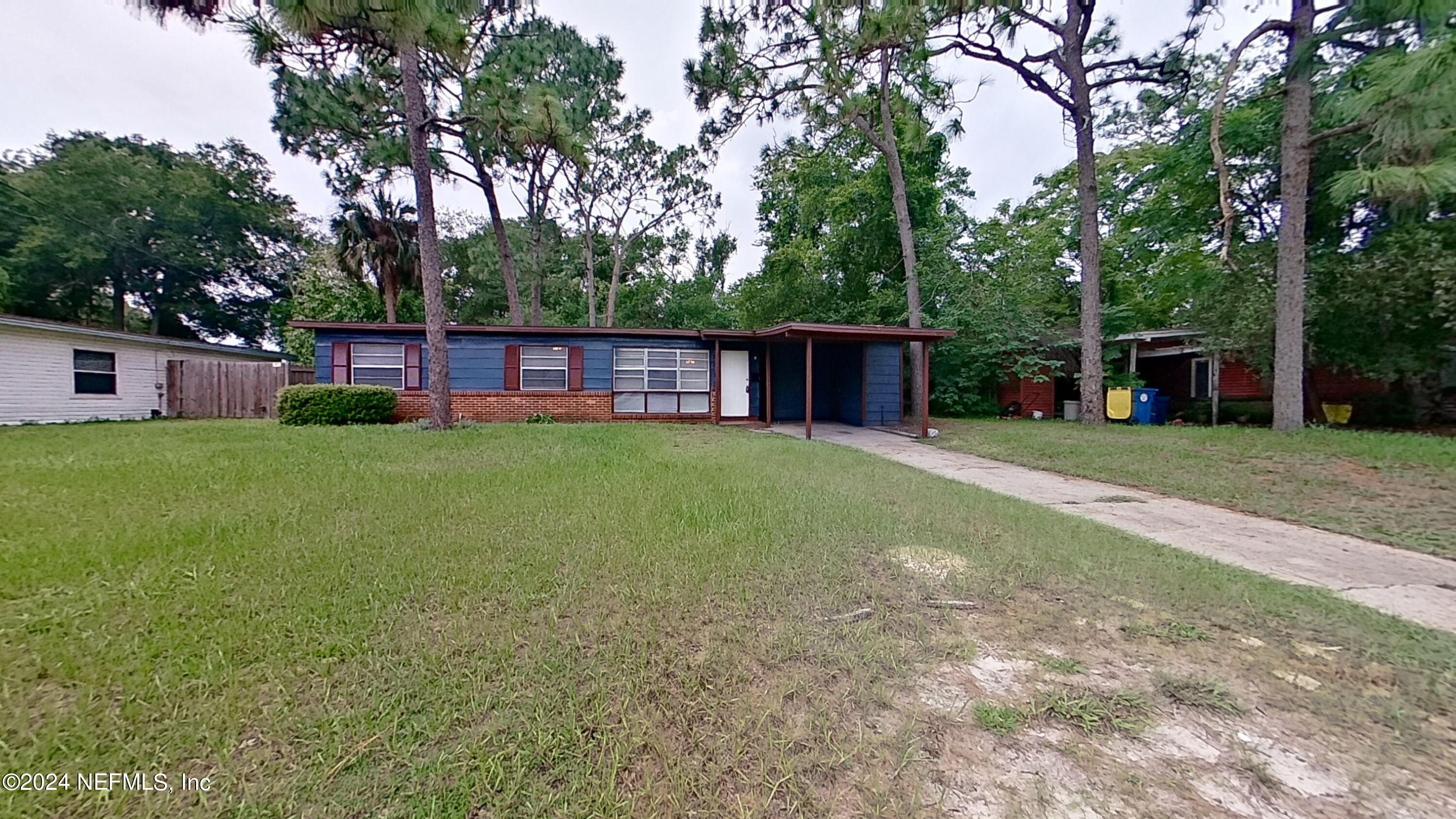 a view of a house with a yard and sitting area