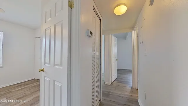 a view of a room with wooden floor and cabinet