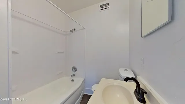 a bathroom with a bathtub and shower