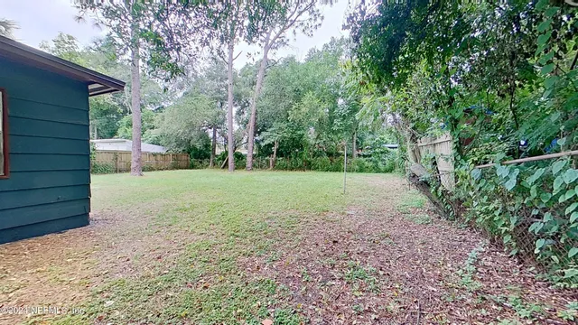 a view of a backyard with large trees