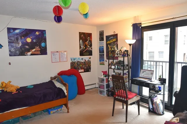 a bedroom with furniture and a large window