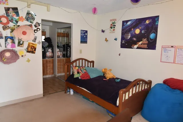 a living room with furniture and wall paintings