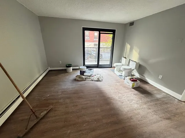 a view of a room with gym equipment and a window