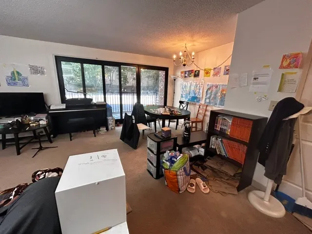 a living room filled with furniture a window and a flat screen tv