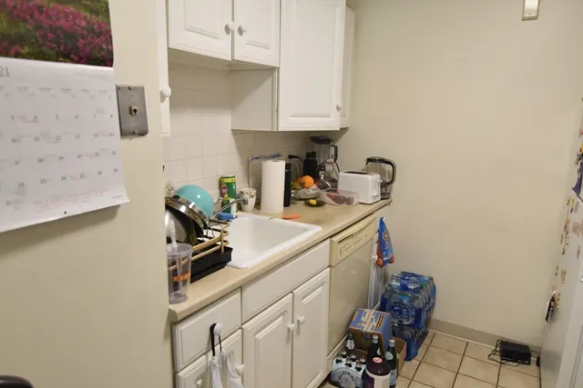 a kitchen with a sink cabinets and utility
