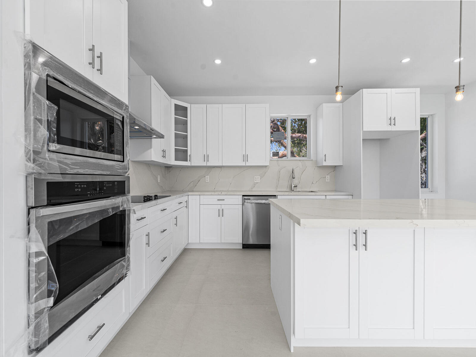 101 Kay Drive Key Largo, FL 33037 - Photo 21 of 71 a kitchen with stainless steel appliances granite countertop a stove a sink and a microwave